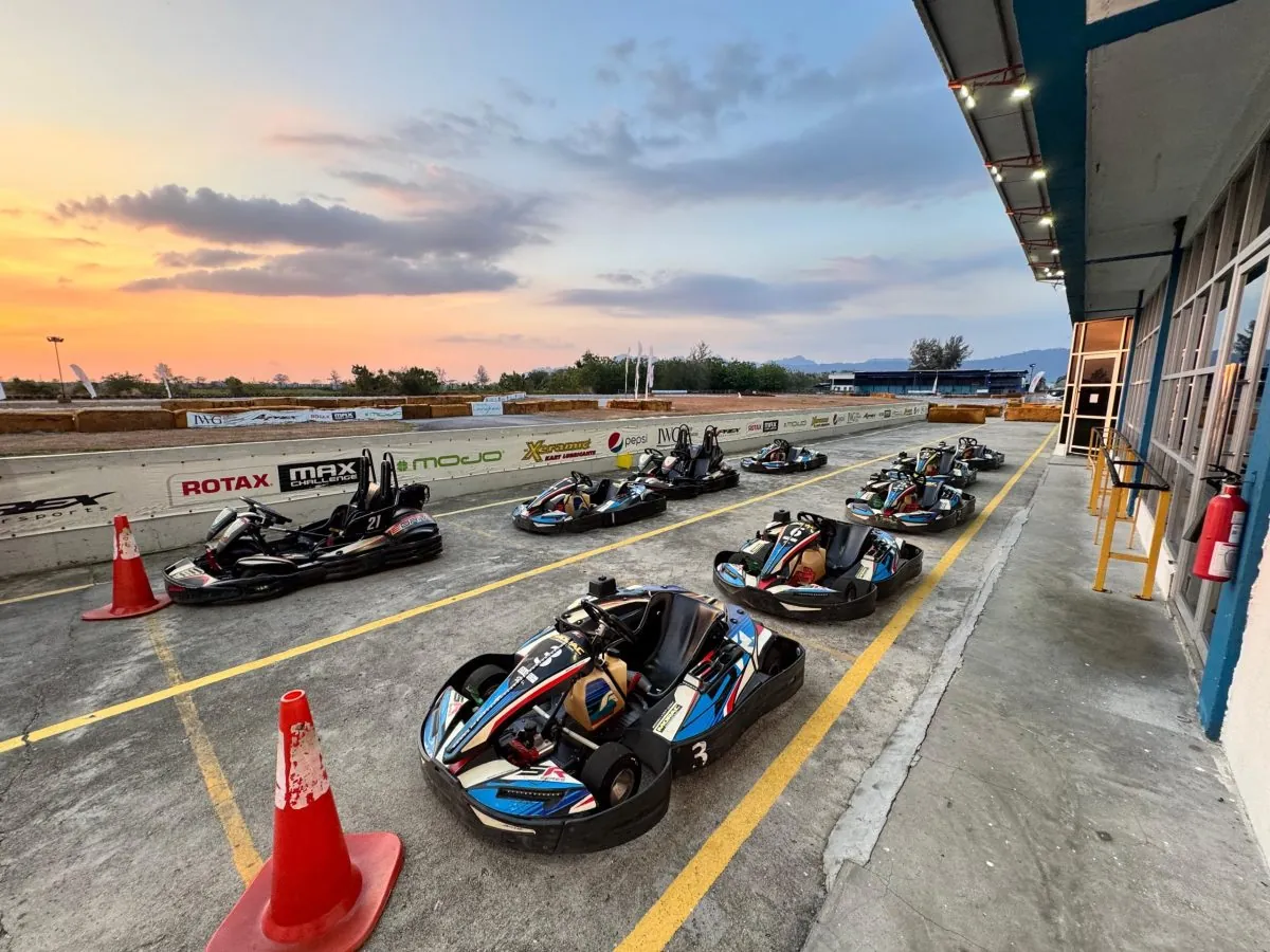 Go-karts lined up in the pit area beside the track at Morac Adventure Park in Langkawi